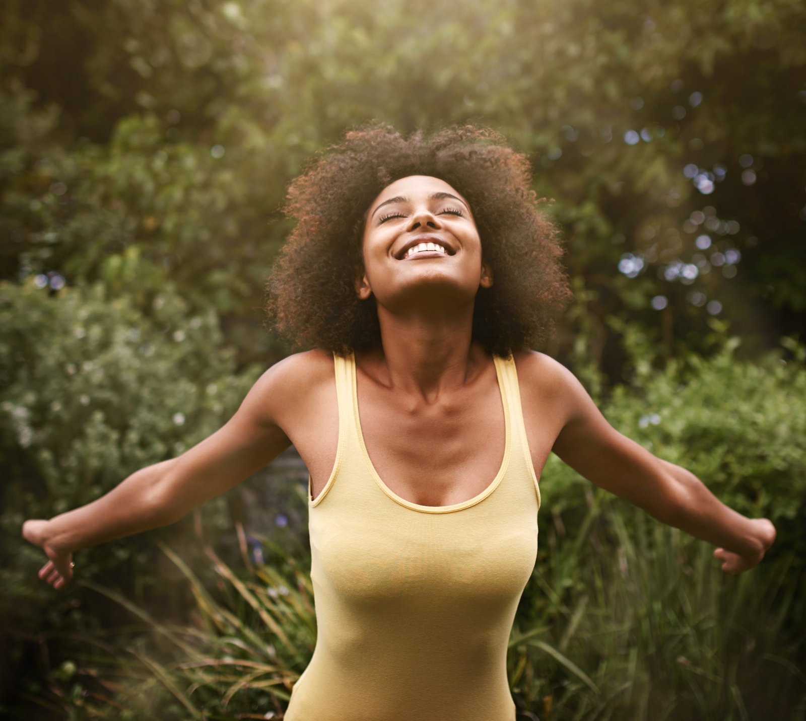 happy open arms black woman nature freedom adventure relax park smile excited person with happiness positive attitude fun outdoors holiday vacation weekend scaled