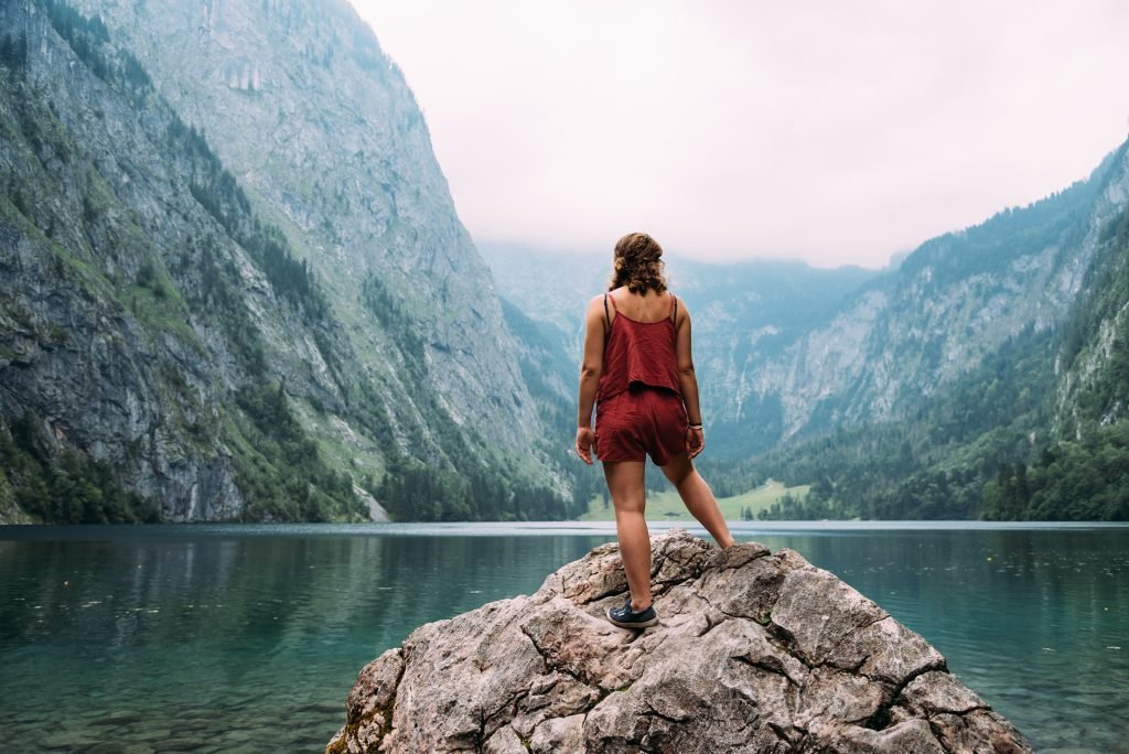 rear view young woman standing lake against mountain scaled
